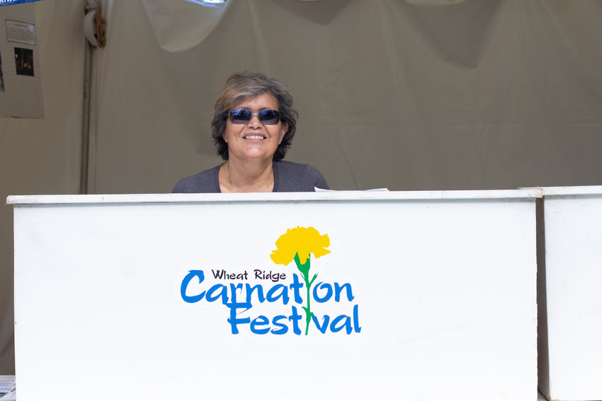 Joan Chavez-Lee sells tickets during the annual Wheat Ridge Carnation Festival.
